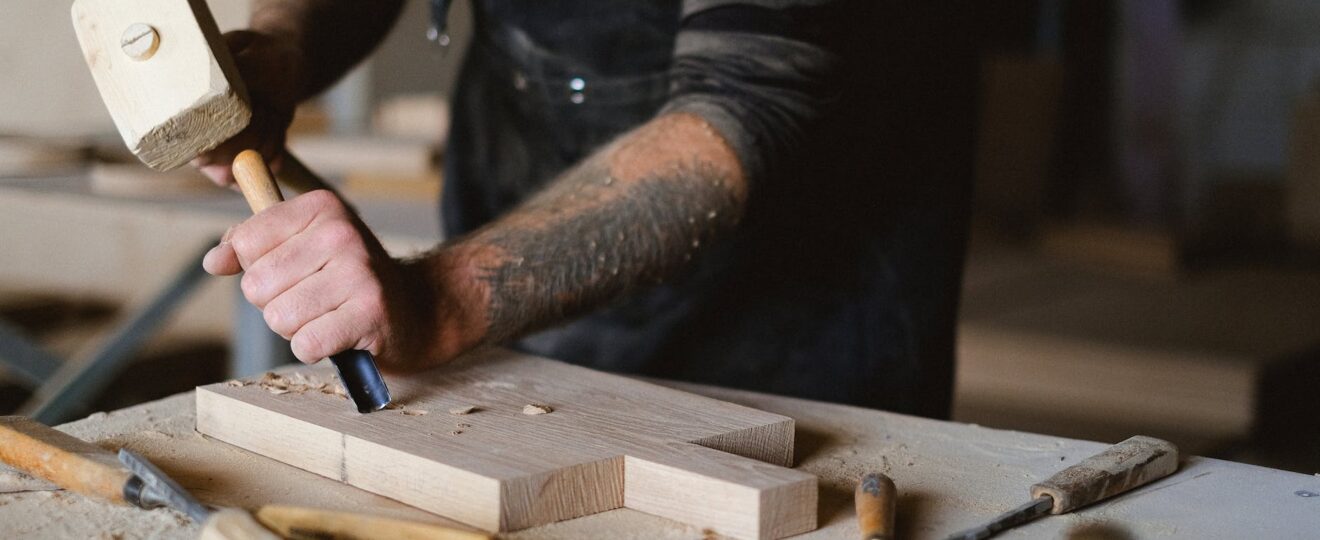 crop carpenter with chisel carving wood
