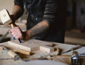 crop carpenter with chisel carving wood
